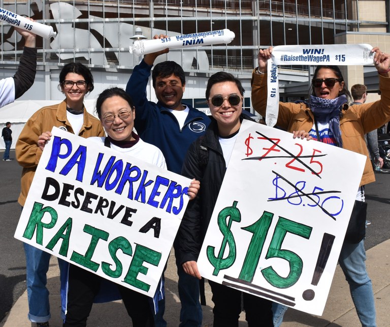 Dr. Jinyoung Park (front left) canvasses for a living wage outside a Penn State football game on October 5